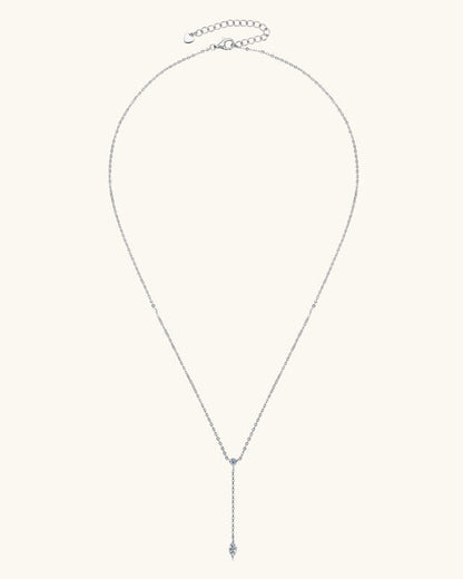 Silver necklace with a small blue gemstone on a white background