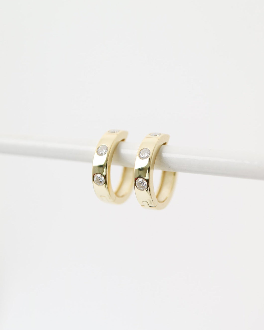 Gold hoop earrings on a white background