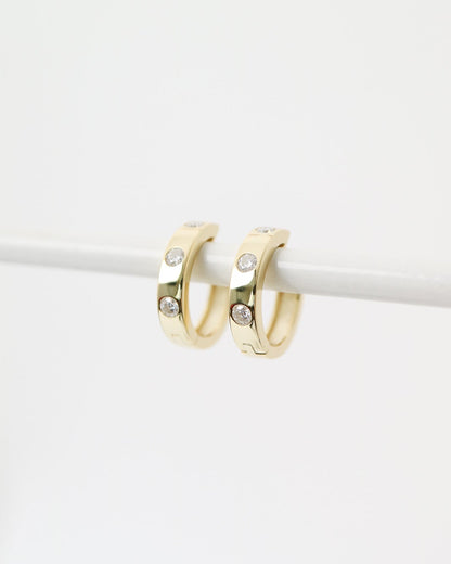 Gold hoop earrings on a white background