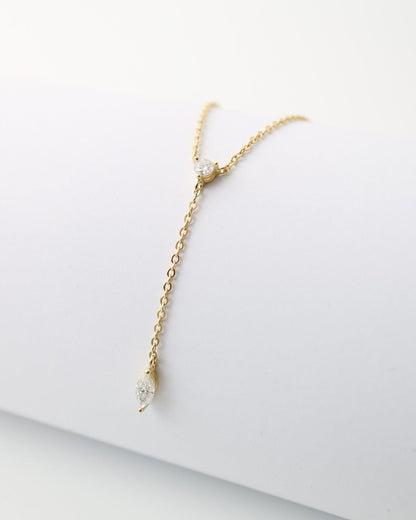Gold bracelet on a white surface