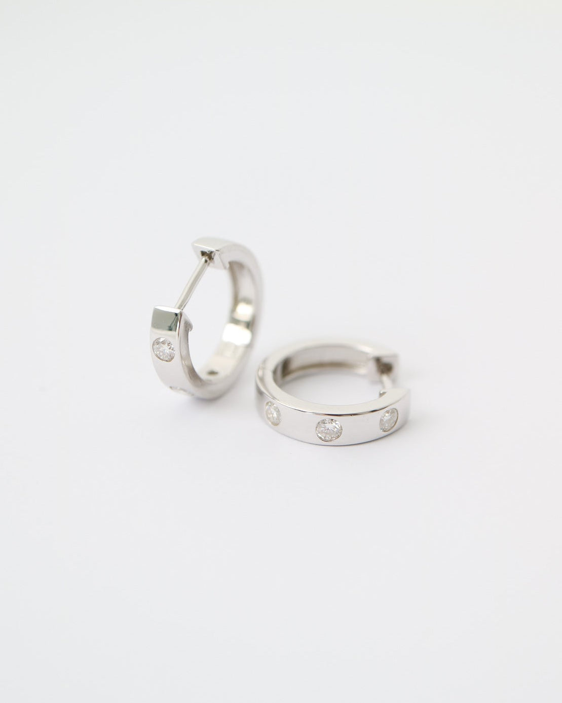 Two silver hoop earrings on a white background