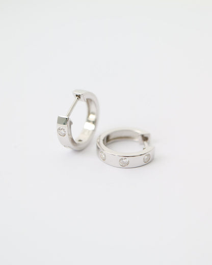 Two silver hoop earrings on a white background