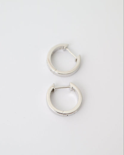Pair of silver hoop earrings on a light gray background