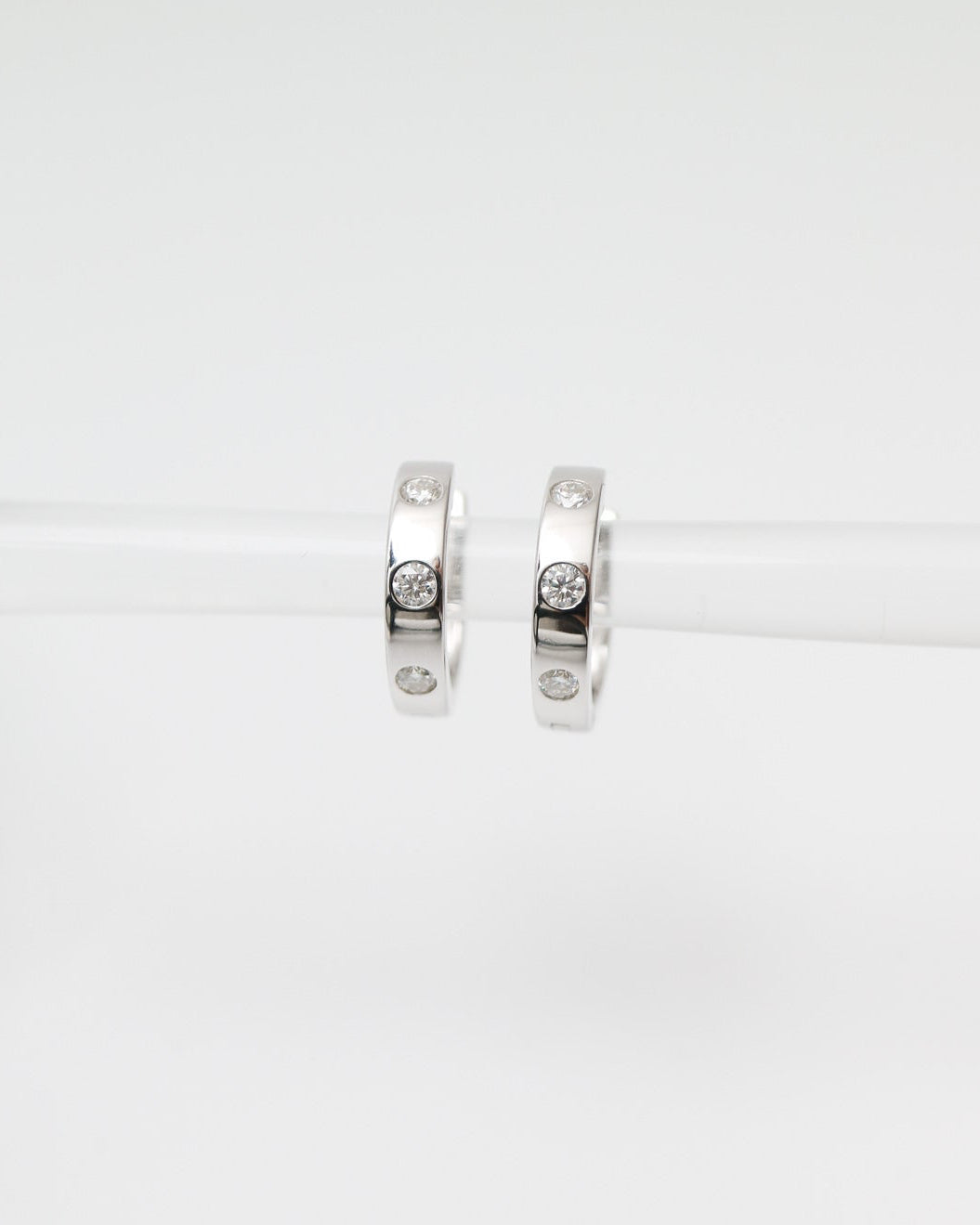 Pair of silver hoop earrings on a white background