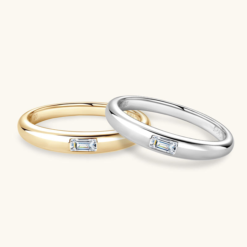 Two rings, one gold and one silver, with embedded diamonds on a white background
