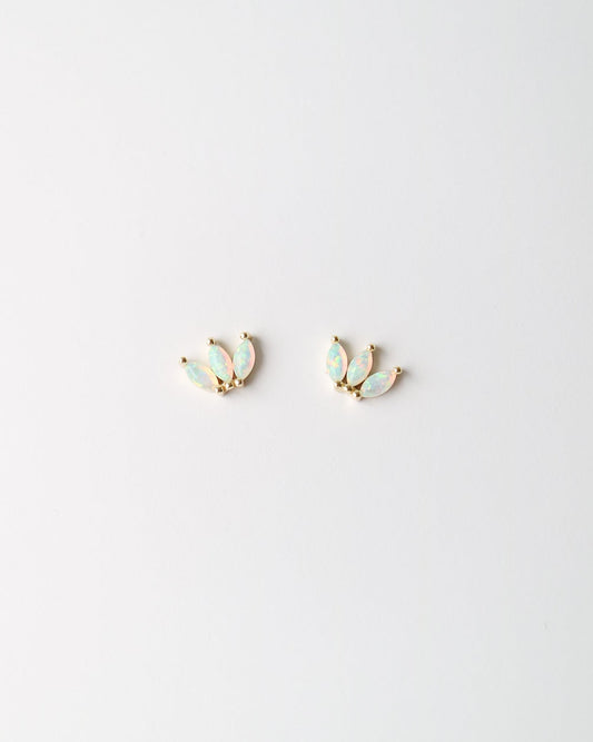 A pair of small gold-toned stud earrings with iridescent pale blue-green opal inlays, shown on a plain white background.