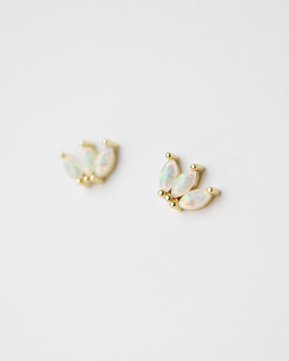 A pair of gold crescent moon stud earrings with iridescent white opal inlays, displayed on a clean white background.