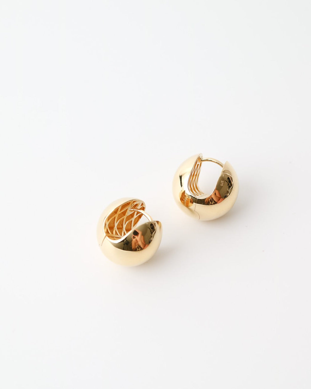 Gold hoop earrings on a white background