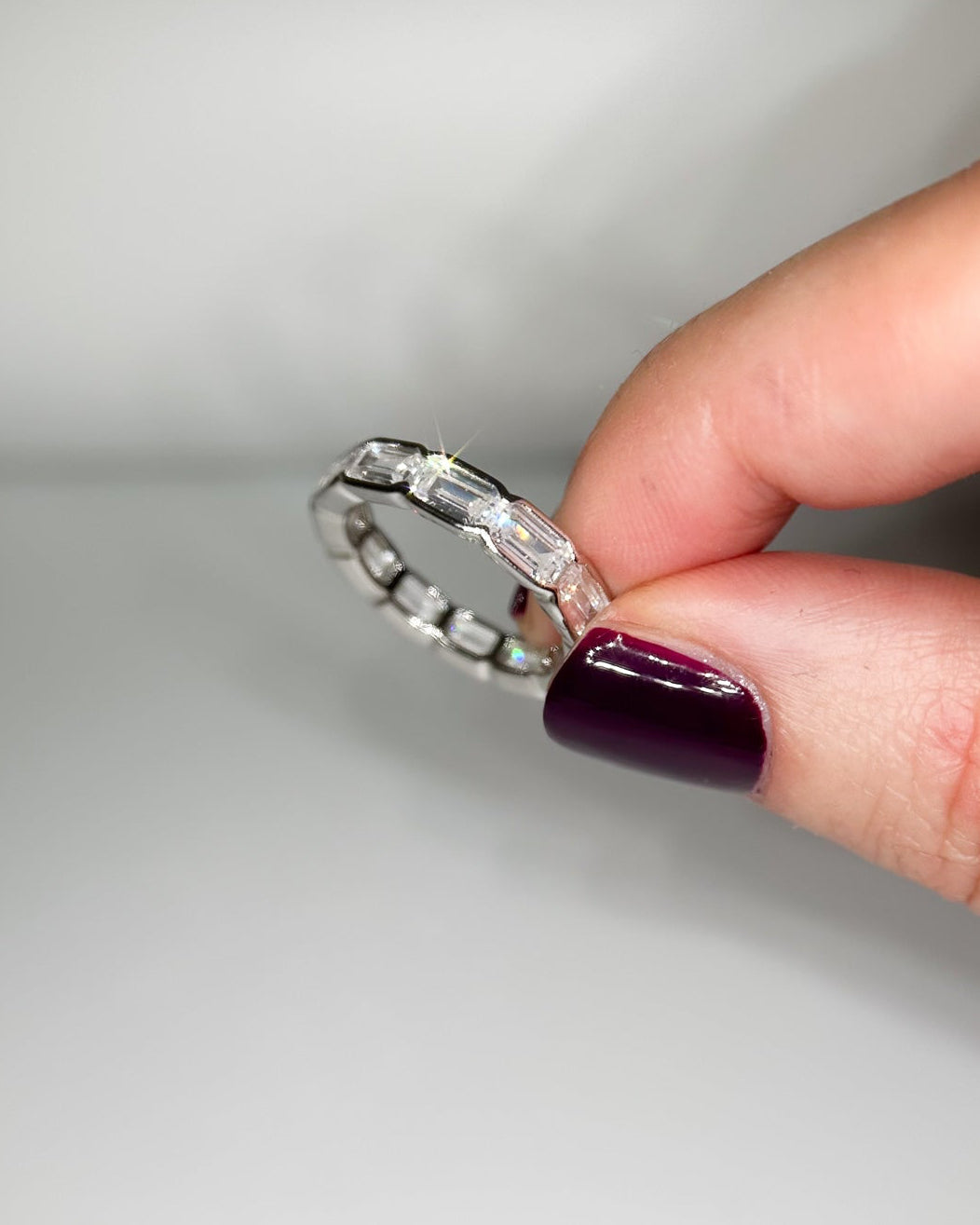 Prism Eternity Band in sterling silver featuring emerald-cut moissanite stones in a full eternity design.