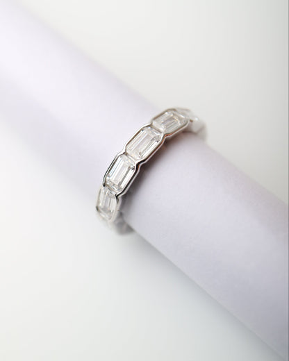 Prism Eternity Band in sterling silver featuring emerald-cut moissanite stones in a full eternity design.