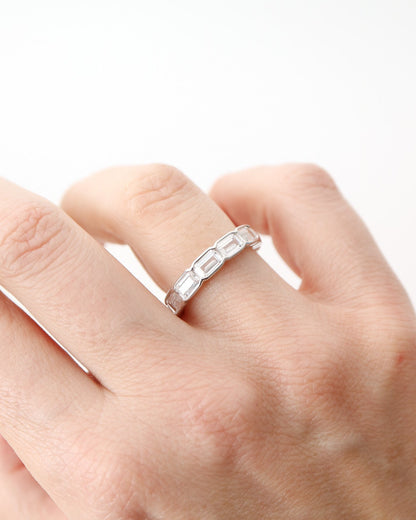 Prism Eternity Band in sterling silver featuring emerald-cut moissanite stones in a full eternity design.