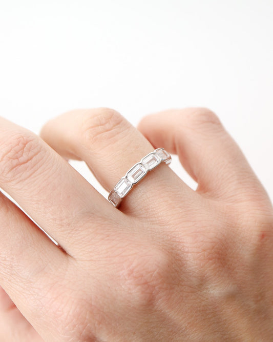 Prism Eternity Band in sterling silver featuring emerald-cut moissanite stones in a full eternity design.