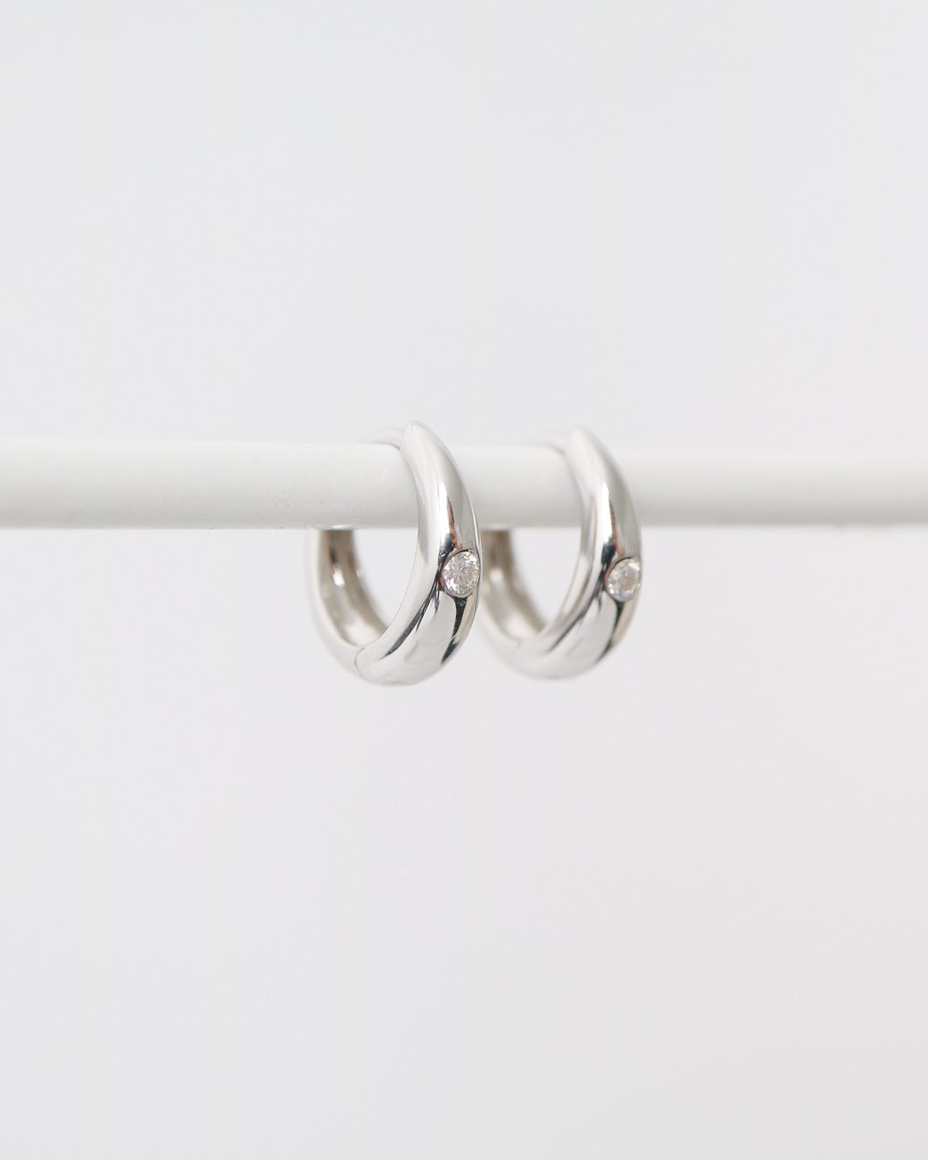 Pair of silver hoop earrings on a white background