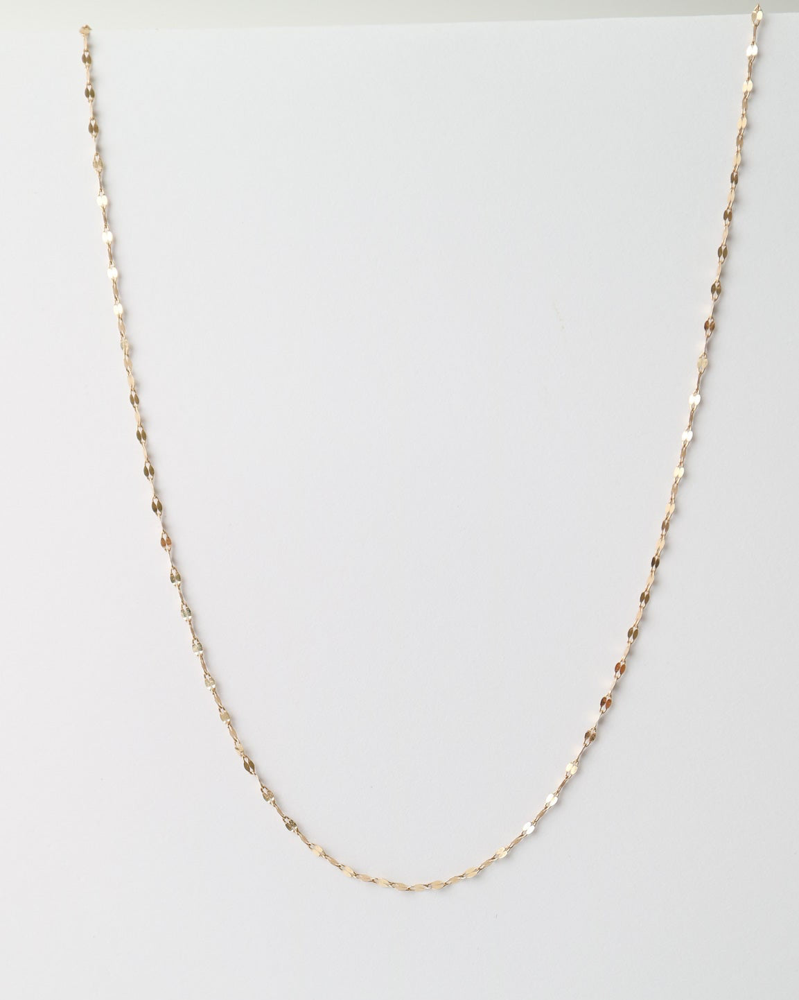 Fine 10ct yellow gold Whispers Chain with delicate faceted links and a polished finish displayed on a white background.
