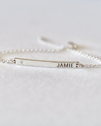 Silver bracelet with name engraving on a white background