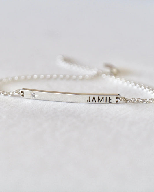 Silver bracelet with name engraving on a white background