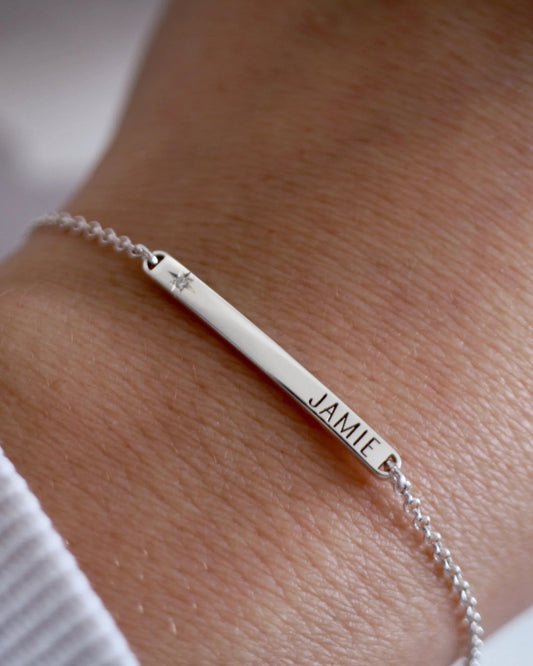 Silver bracelet with engraved name on wrist