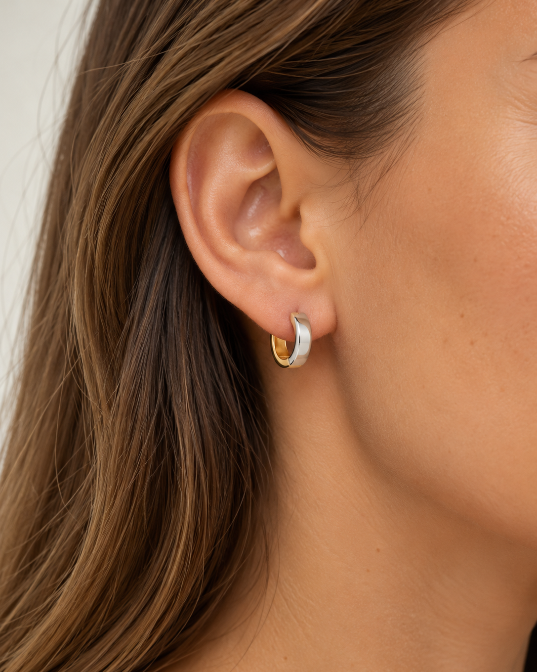 Close-up on ear of 9kt solid gold Two Tone Hoop showcasing their sculptural shape and contrasting gold and silver finishes, perfect for modern everyday styling.
