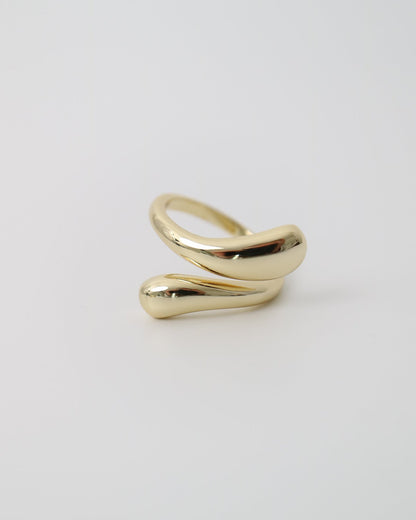 Gold contour ring on a light gray background