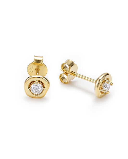A pair of gold stud earrings with a bezel-set round clear gemstone, shown from both front and side angles on a white background.