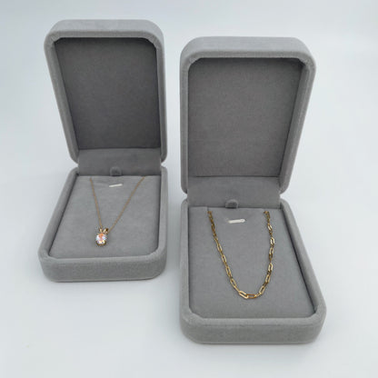 Two grey velvet necklaces boxes, open and placed side by side