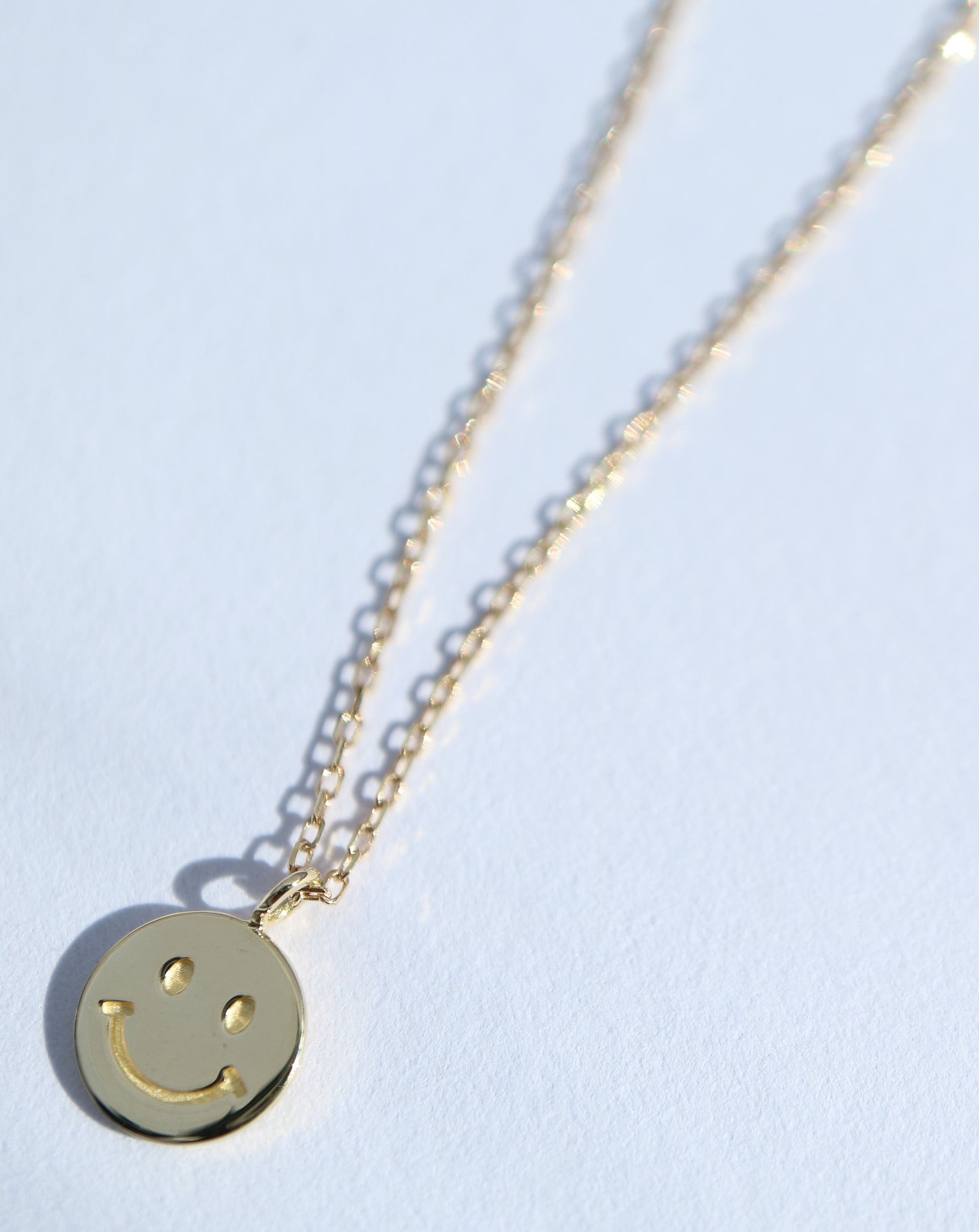9kt gold necklace with smiley face pendant