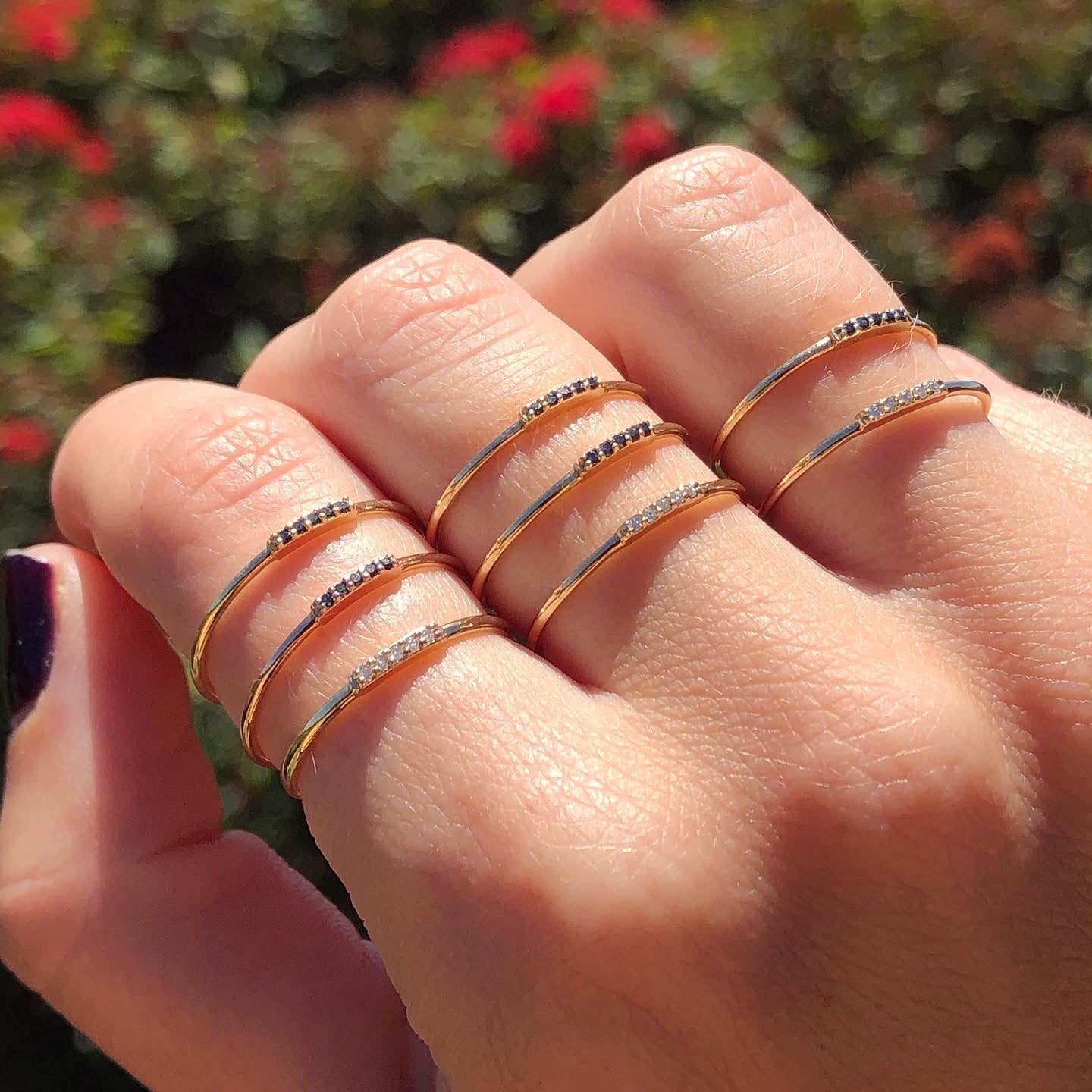 Stacking gold and natural diamond rings on hand