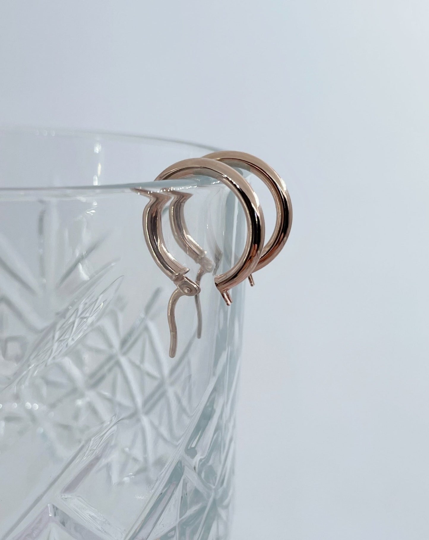 9kt Rose Gold Amelia Hoop Earrings on glass