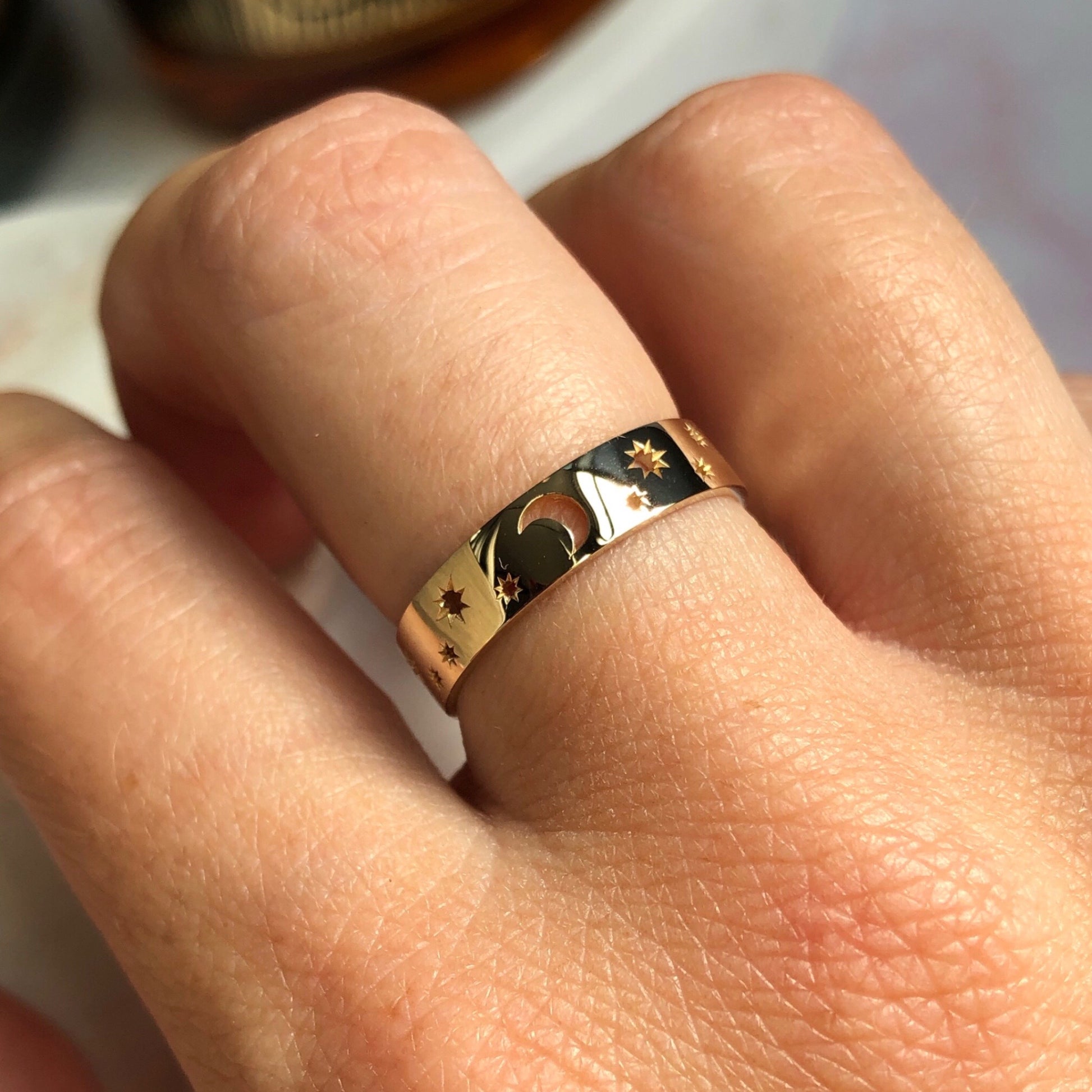10kt solid gold celestial ring with stars and moon motif, modelled on hand