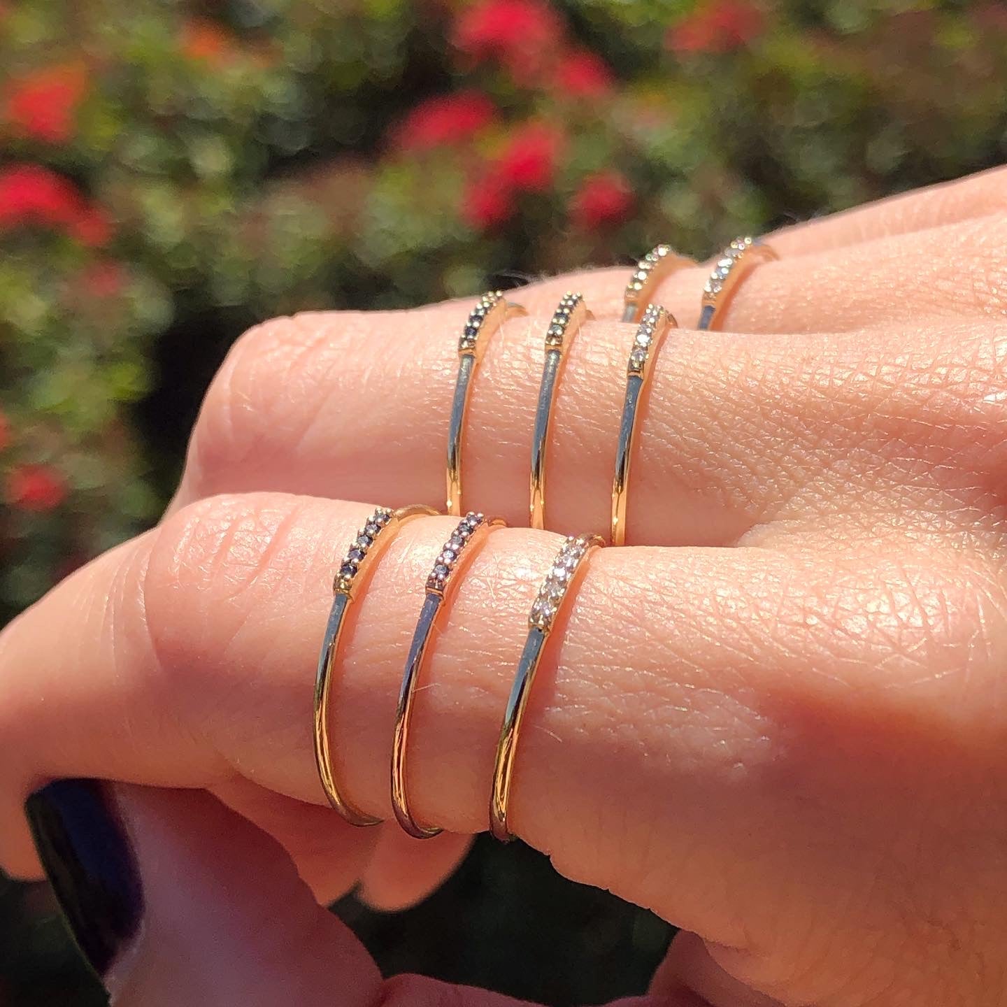 Gold and diamond stacking rings on human hand