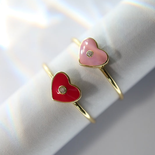 Gold rings with heart motif and pink enamel