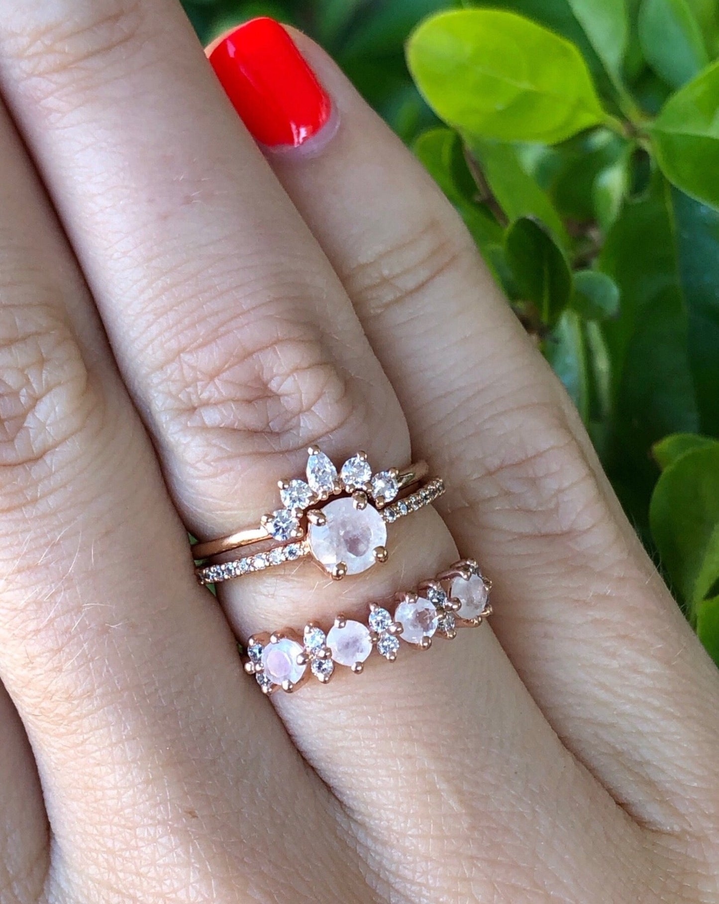 Rose gold and gemstone stacking rings on hand