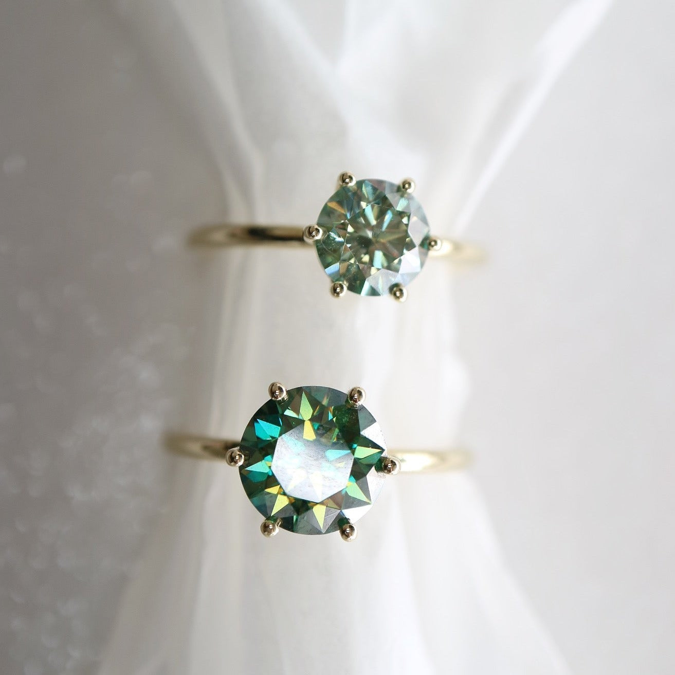 Solid gold and blue moissanite rings