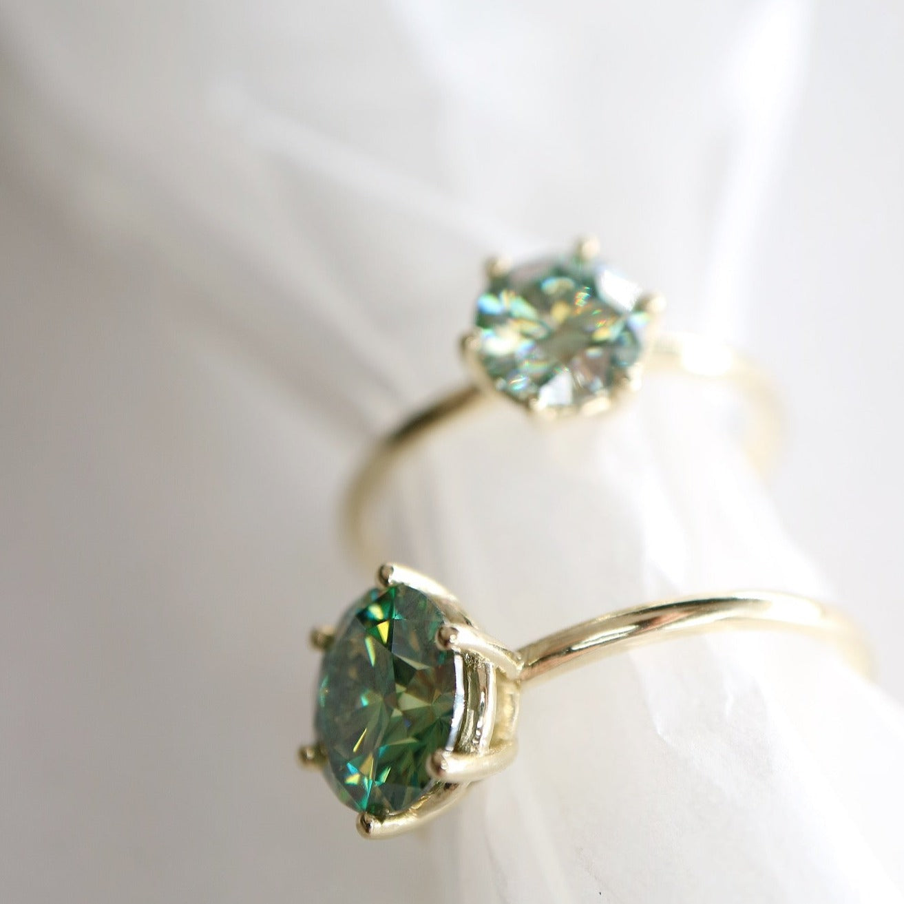 Solid gold and blue moissanite rings
