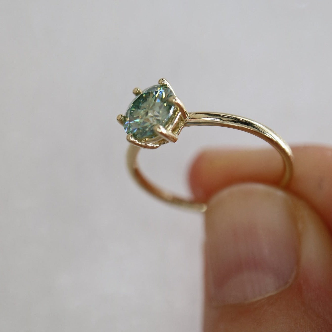 Solid gold and blue moissanite ring