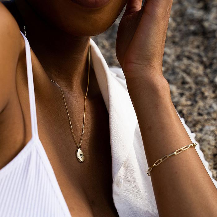 Silver Bee Pendant by Meraki Jewellery Design, shown on black female