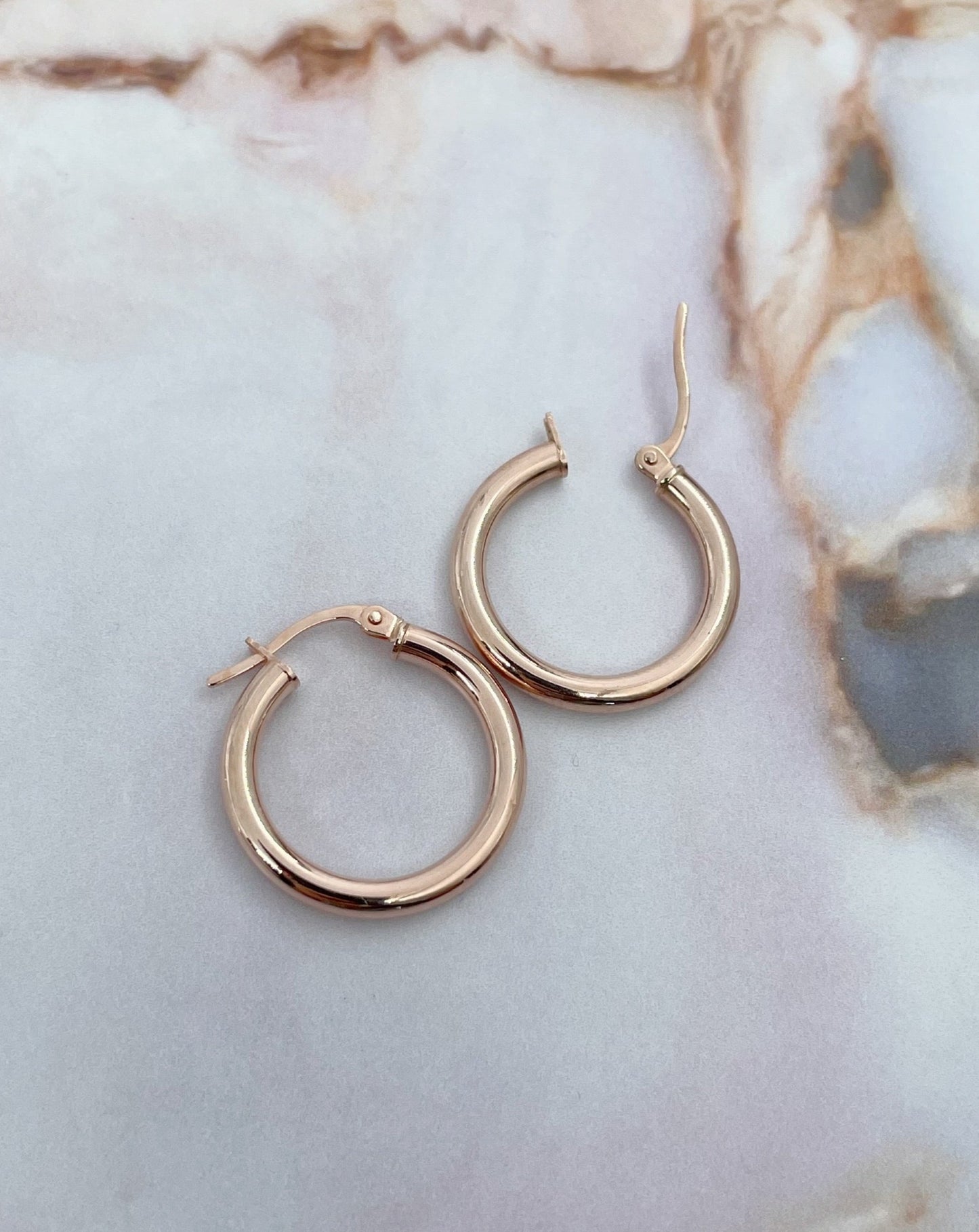 Collective & Co. 9kt Rose Gold Hoops on marble.