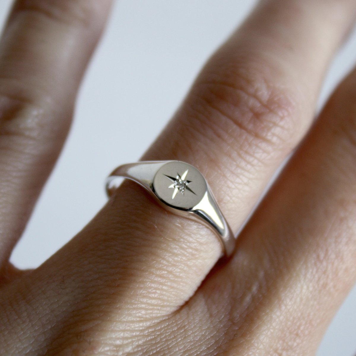 Celestial signet ring on hand