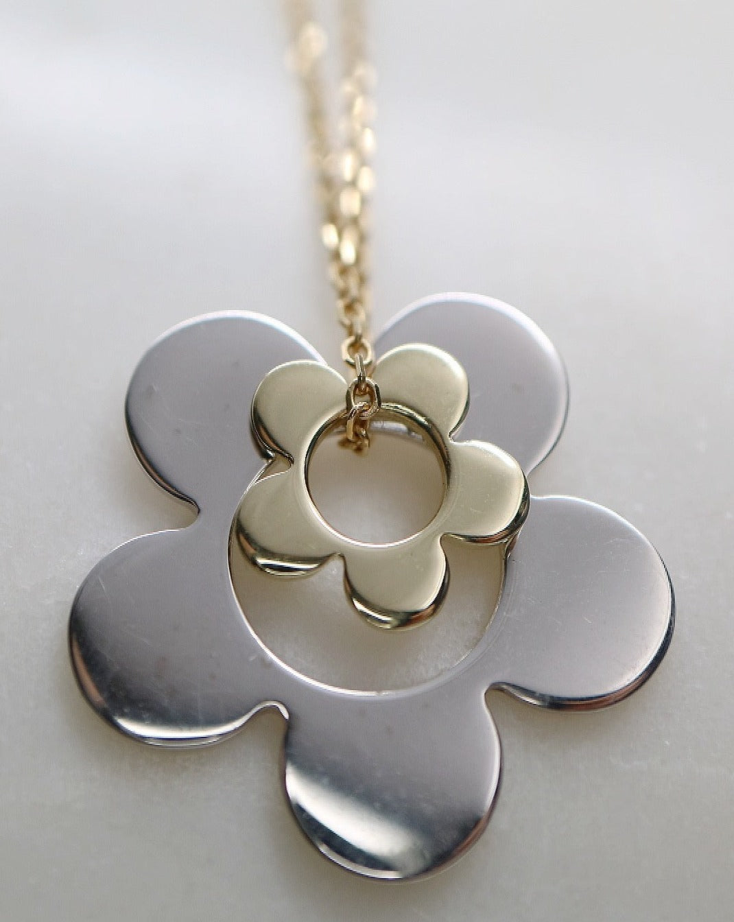 Silver and gold daisy charms on gold chain