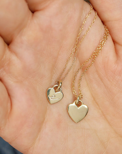 9kt Gold Heart Pendants in hand